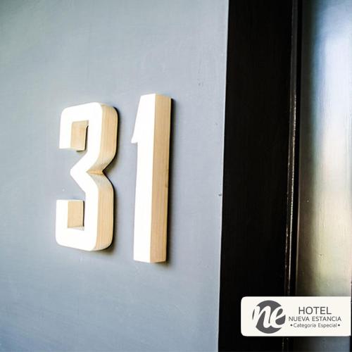 a number on a wall next to a door at NEhotel Nueva Estancia in León