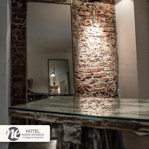 a mirror on top of a counter in a room at NEhotel Nueva Estancia in León