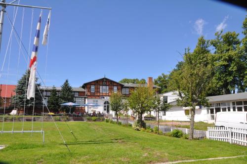 a park with a soccer field and a house at Pension Zum Alten Fährhaus in Rostock