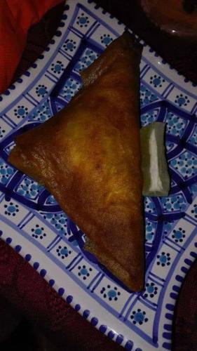 a piece of food on a blue and white plate at Dar El Kasba Riad Guest House in Bizerte