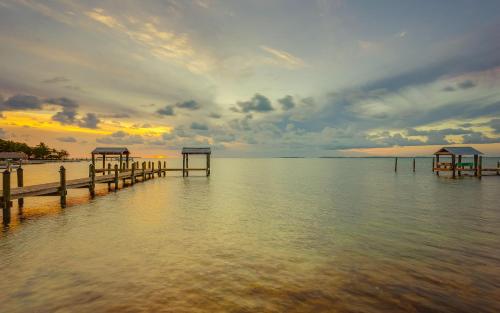 a dock in the water under a cloudy sky at Drift Hotel in Key Largo