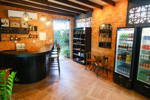 a bar in a restaurant with a brick wall at Hotel Ecos Classic in Porto Velho