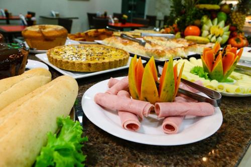 a table topped with plates of food on a counter at Larison Economy by Easy Hotéis in Porto Velho