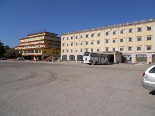 a bus parked in front of a large building at Grand Hotel Pavone in Cassino