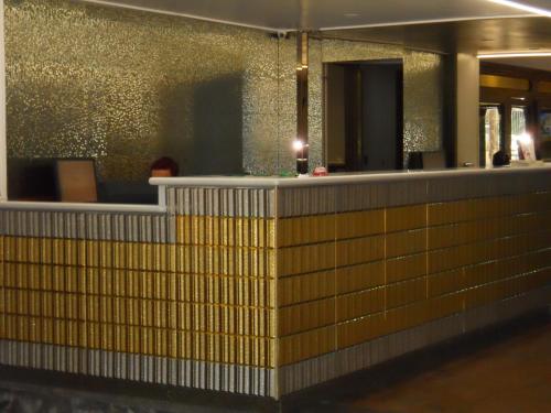 a bar in a building with gold tiles at Grand Hotel Pavone in Cassino