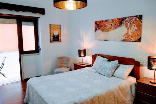 リスボンにあるBelém Street Markets (Ajuda)のベッドルーム1室(ベッド1台、ランプ2つ、椅子付)