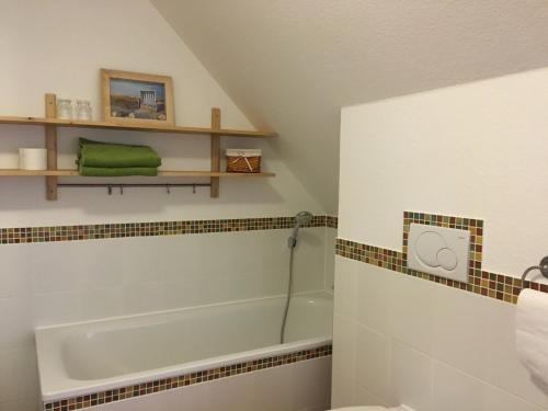 a bathroom with a bath tub and a sink at Flair Landhotel Strengliner Mühle in Pronstorf