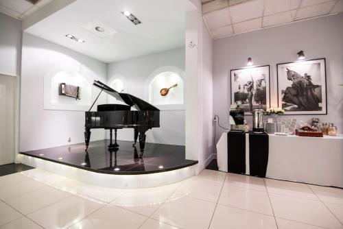 a room with a piano on display in a museum at Park Hotel Bydgoszcz in Bydgoszcz