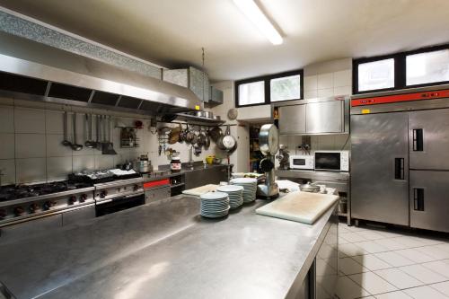 a large kitchen with stainless steel appliances at Hotel Letizia in Orte
