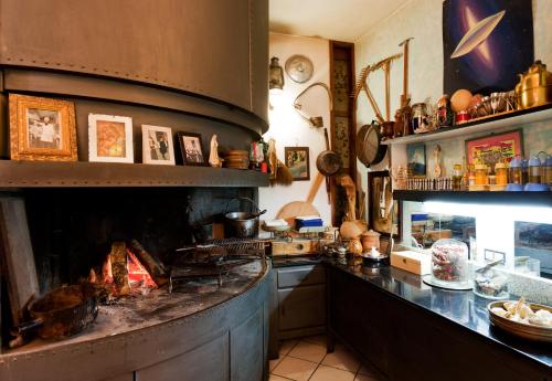 a kitchen with a large fireplace in a kitchen at Hotel Letizia in Orte