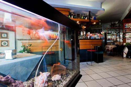 a restaurant with a fish tank in a window at Hotel Letizia in Orte