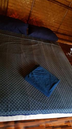a bed with a net on top of it at Lanta Local Hut in Ko Lanta