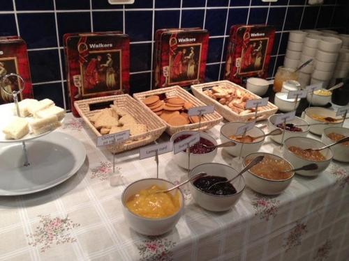 a table topped with bowls of food on a table at STF Kungsgården Långvind in Enånger