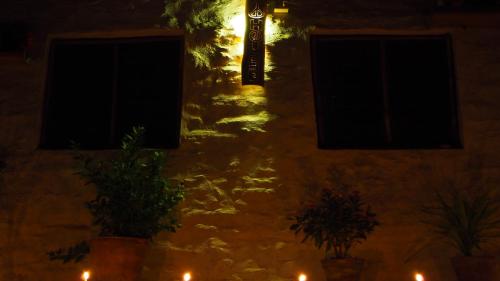 a light on the side of a building at night at Peace Guest House in Pokhara