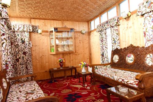 a room with a bed and a couch and a window at White House Group Of Houseboats in Srinagar