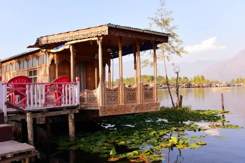 a house on a dock on a body of water at White House Group Of Houseboats in Srinagar