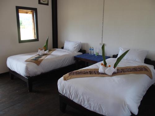 Voodi või voodid majutusasutuse Thongdam Guesthouse toas