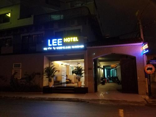 a store with a lit up sign on a street at night at Lee Hotel in Ho Chi Minh City
