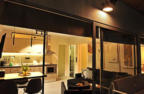 a living room and kitchen with a table and chairs at The Athenians Modern Apartments in Athens