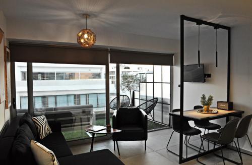 a living room with a couch and a table at The Athenians Modern Apartments in Athens