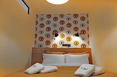 a bed with two white pillows on top of it at The Athenians Modern Apartments in Athens