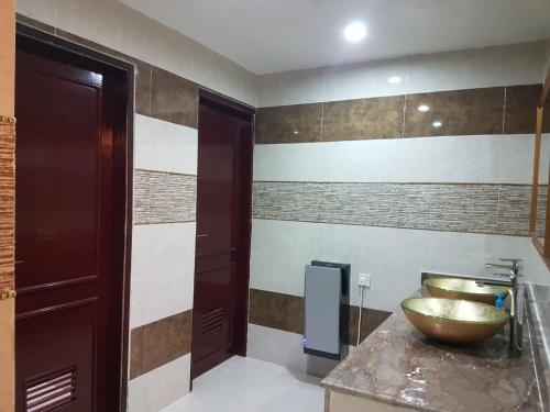 a bathroom with a bowl sink on a counter at Turtle Beach Resort in Al Ḩadd