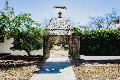 a gate leading into a building with a lighthouse at Hotel Boutique Molino del Arco in Ronda