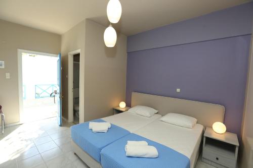 a bedroom with a bed with two towels on it at Blue Sky in Galissas