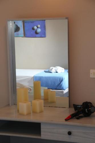 a mirror on a table with a pile of cheese at Blue Sky in Galissas