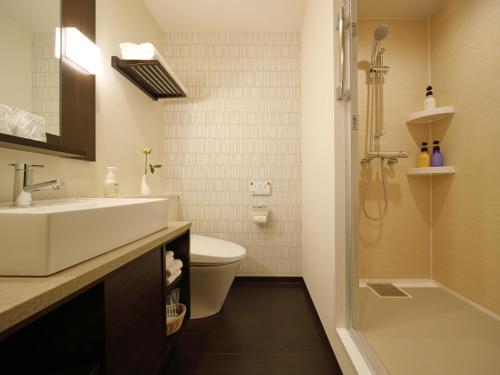 a bathroom with a sink and a toilet and a shower at Red Roof Inn & Suites Osaka Namba Nipponbashi in Osaka
