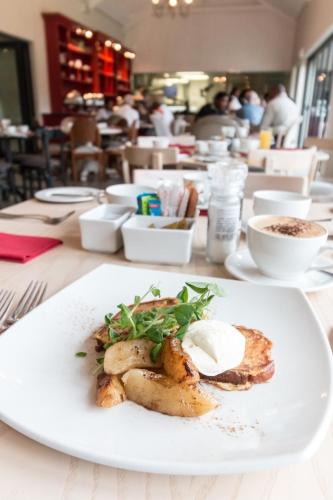 a white plate with food on a table at Royal St. Andrews Hotel, Spa and Conference Centre in Port Alfred