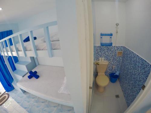 a white bunk bed with a toilet in a room at The BIGGIES Inn in Oslob