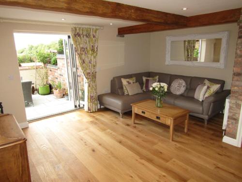 a living room with a couch and a table at Jockhedge Holiday Cottages in Skegness