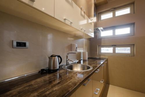 a kitchen with a sink and a counter top at Apart K Apartments in Belgrade
