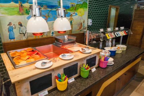 a buffet in a restaurant with food on a counter at Alfagar Alto da Colina in Albufeira