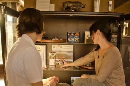 two women looking at a display case in a store at Morokolo Safari Lodge Self-catering in Pilanesberg