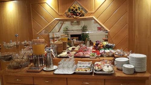 a buffet of food on a table in a restaurant at ARRIVEL Hotel am Bergson - bisher Hotel Neuner in Munich