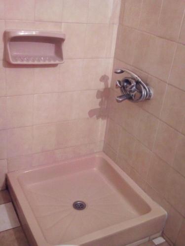a shower with a bath tub in a bathroom at Dimitra Pentaliou Rooms in Kamena Vourla