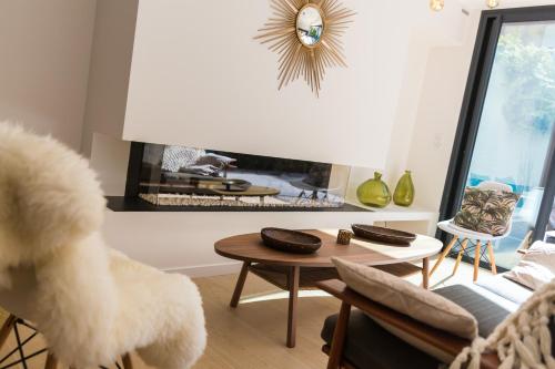 a living room filled with furniture and a dog at La Maison Odeia Bordeaux Centre in Bordeaux