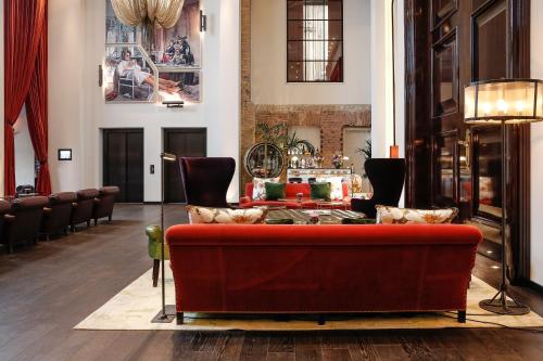 a living room filled with furniture and a fireplace at Hotel Zoo Berlin in Berlin