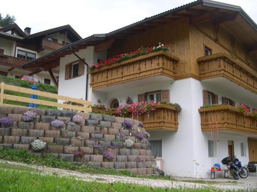 a house with flower boxes on the side of it at Cèsa Chri e Sofì in Campitello di Fassa