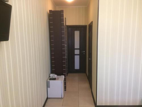 a hallway with a room with a door and a box at Hotel Grant in Kharkiv