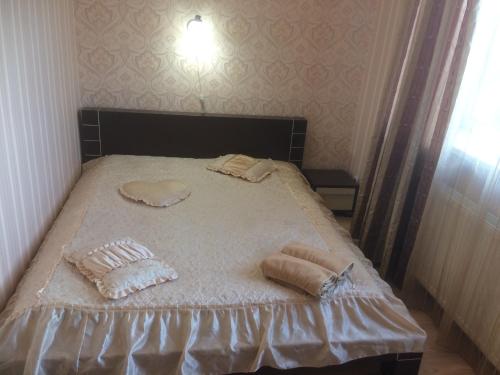 a bed with two pillows on it in a room at Hotel Grant in Kharkiv