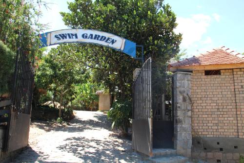 a gate to a yard with a swing garden at Maison entière ChezSoa, antananarivo in Andoharanofotsy
