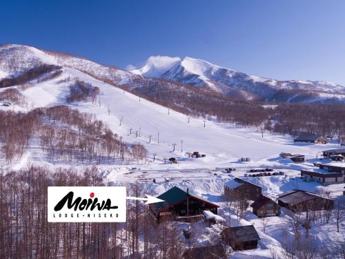 a ski resort in the snow with a ski slope at Moiwa Lodge in Niseko