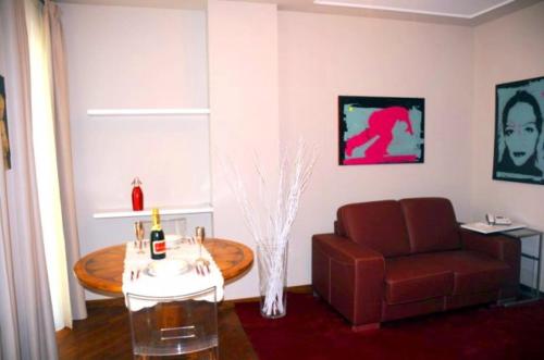 a living room with a couch and a table and a chair at Residenza Segrate Centro Segrate in Segrate