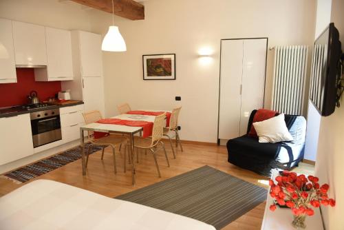 a kitchen and living room with a table and chairs at Il Vicolo in Como