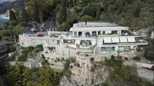 a house on the side of a mountain at Maison Blanche Taormina in Taormina