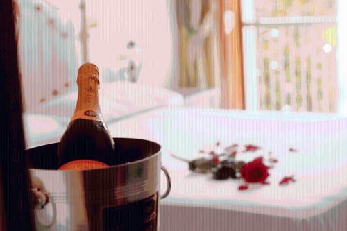 a bottle of champagne in a bucket on a table at Fortuna Resort in Chianciano Terme