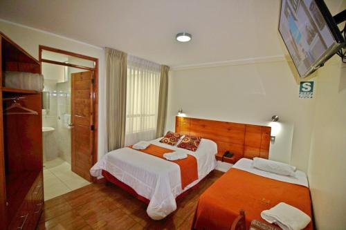 Postel nebo postele na pokoji v ubytování Munayki Hotel